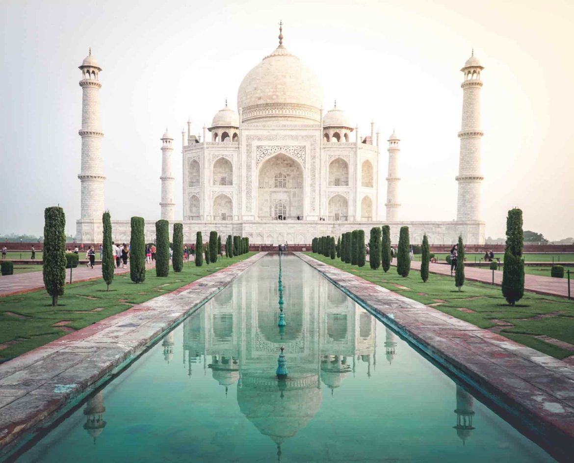 Symmetrical view of the Taj Mahal reflecting in the garden pool during a cultural trip idia.